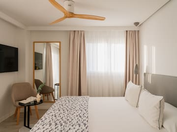 a room with a bed and a fan