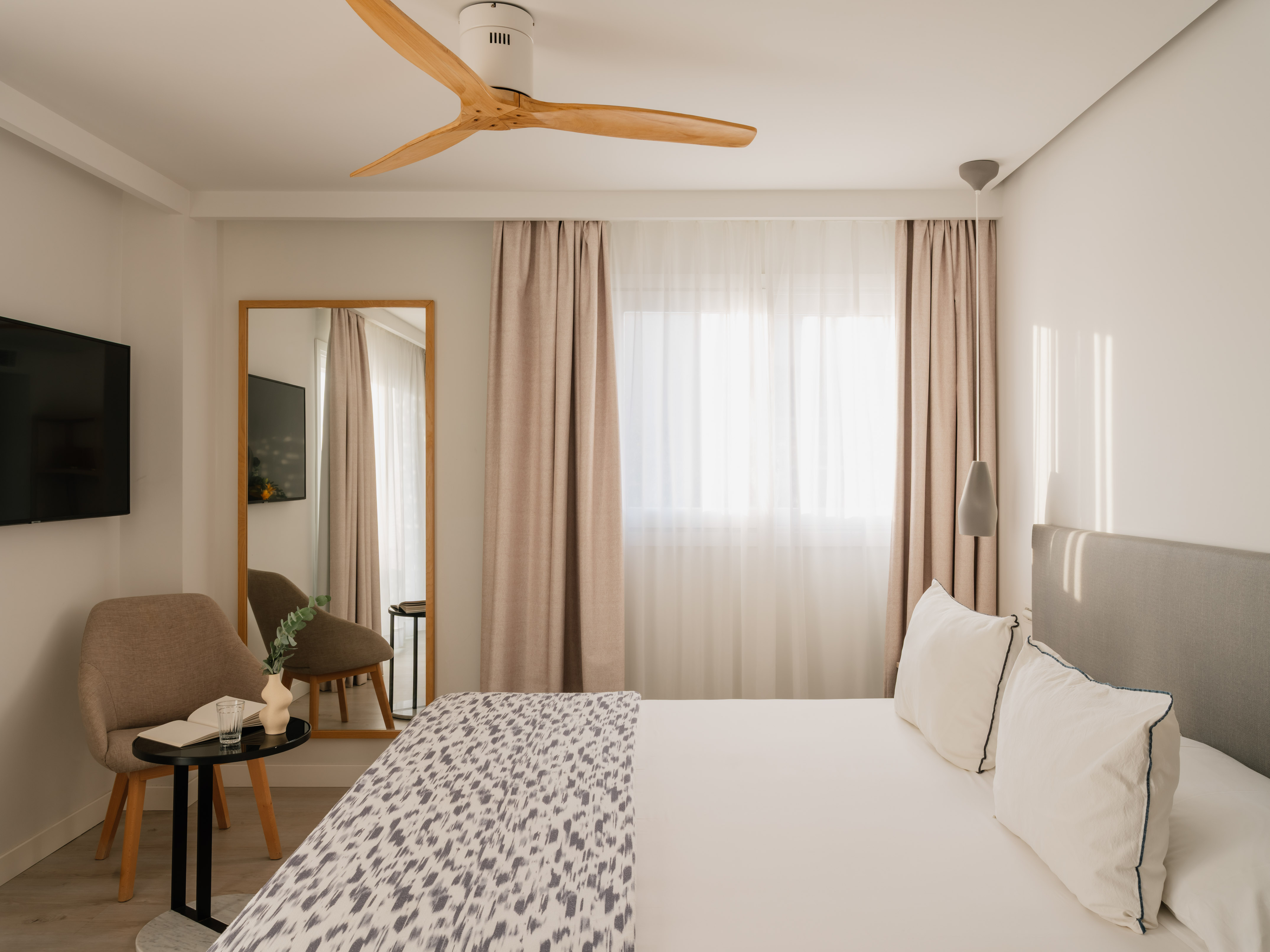 a room with a bed and a fan