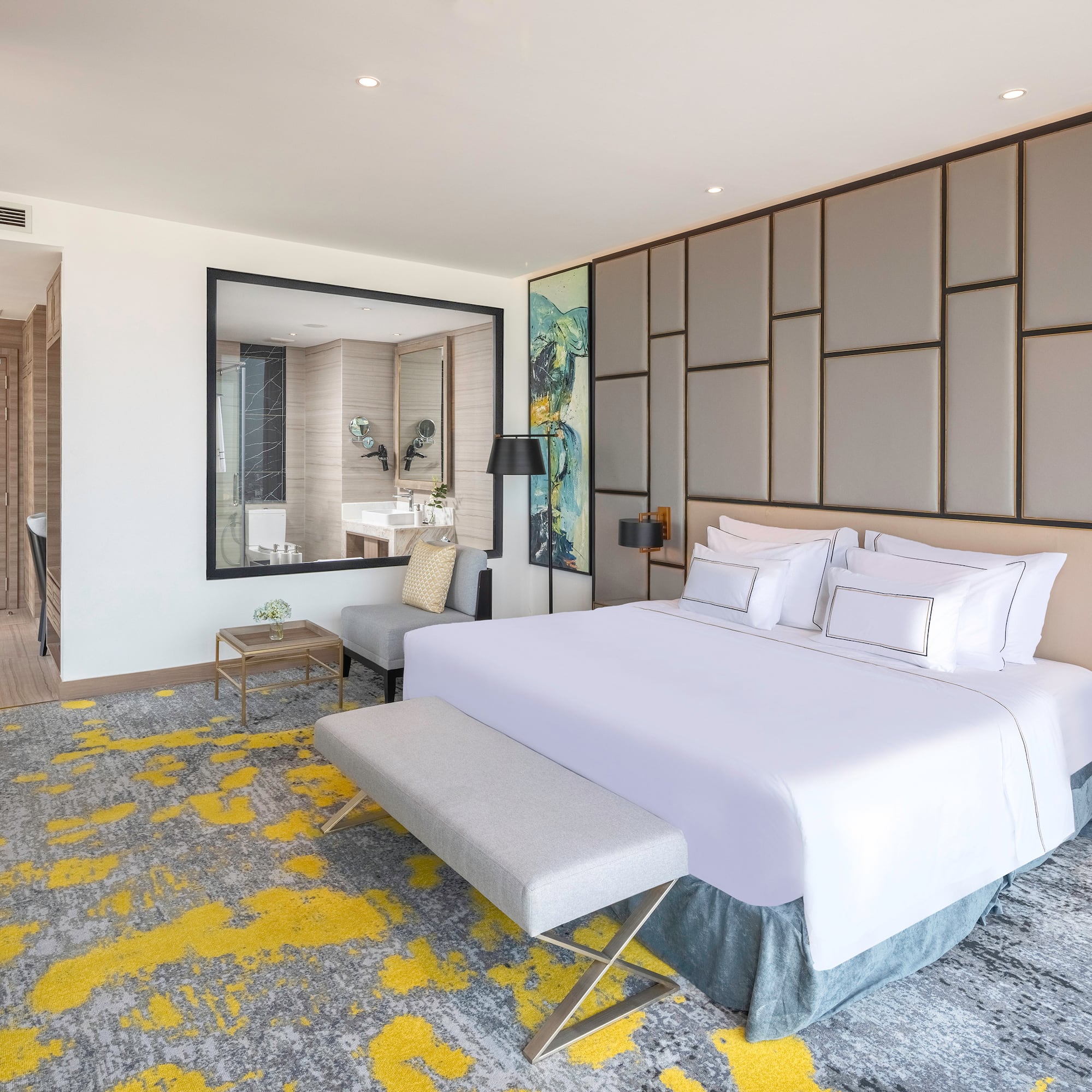 a bedroom with a large bed and a mirror