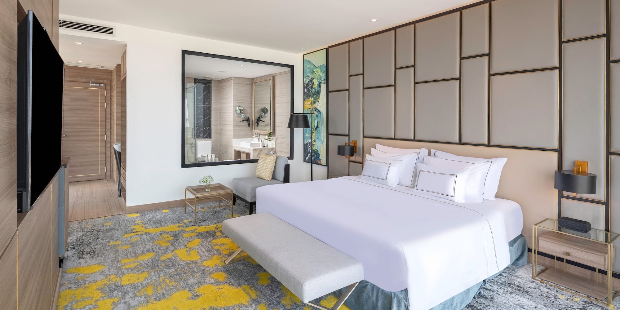 a bedroom with a large bed and a mirror