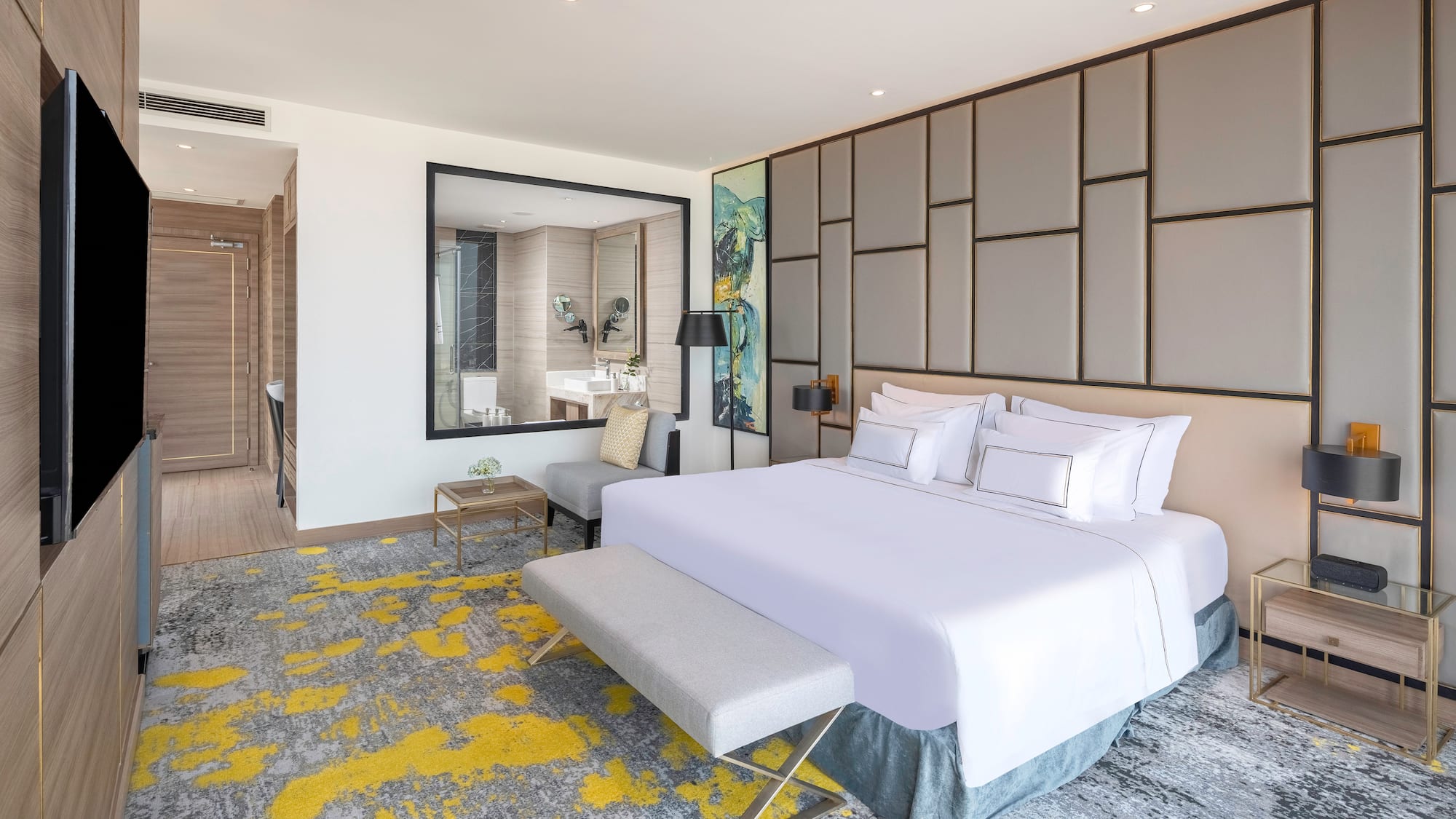 a bedroom with a large bed and a mirror