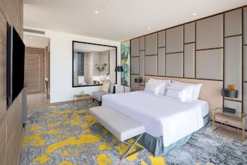 a bedroom with a large bed and a mirror