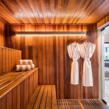 a sauna with towels on a rack