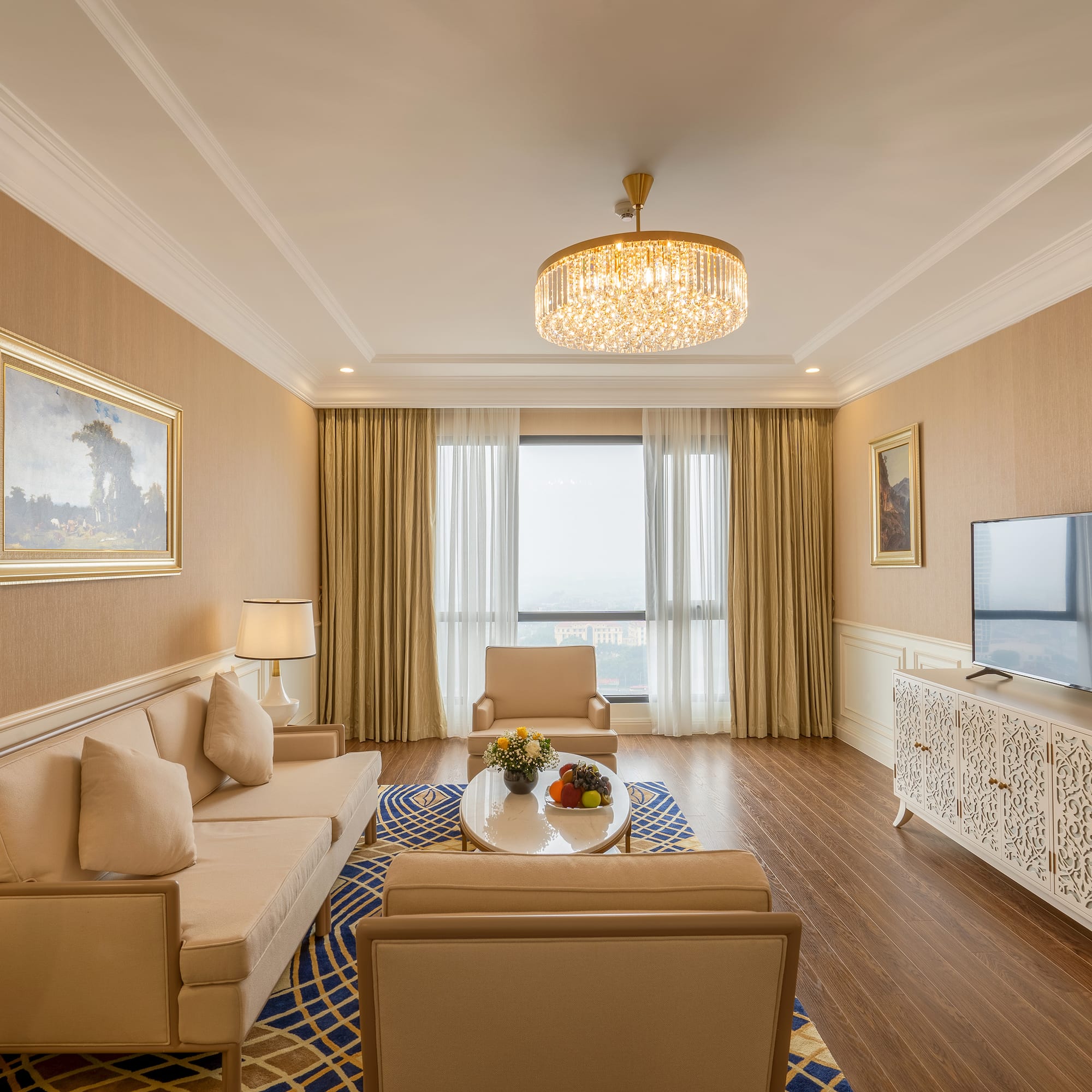 a living room with a chandelier and couches