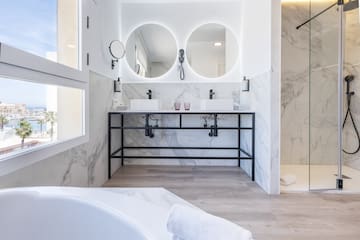 a bathroom with marble walls and a tub