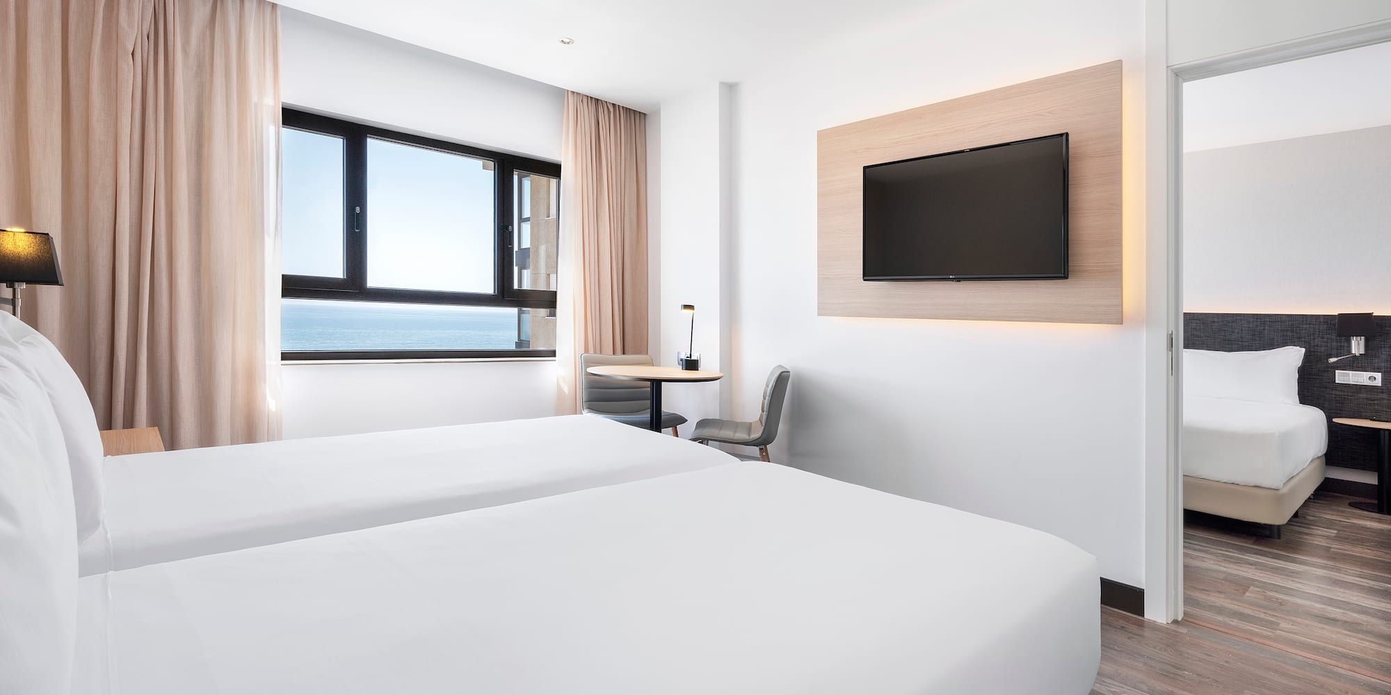 a room with two beds and a television