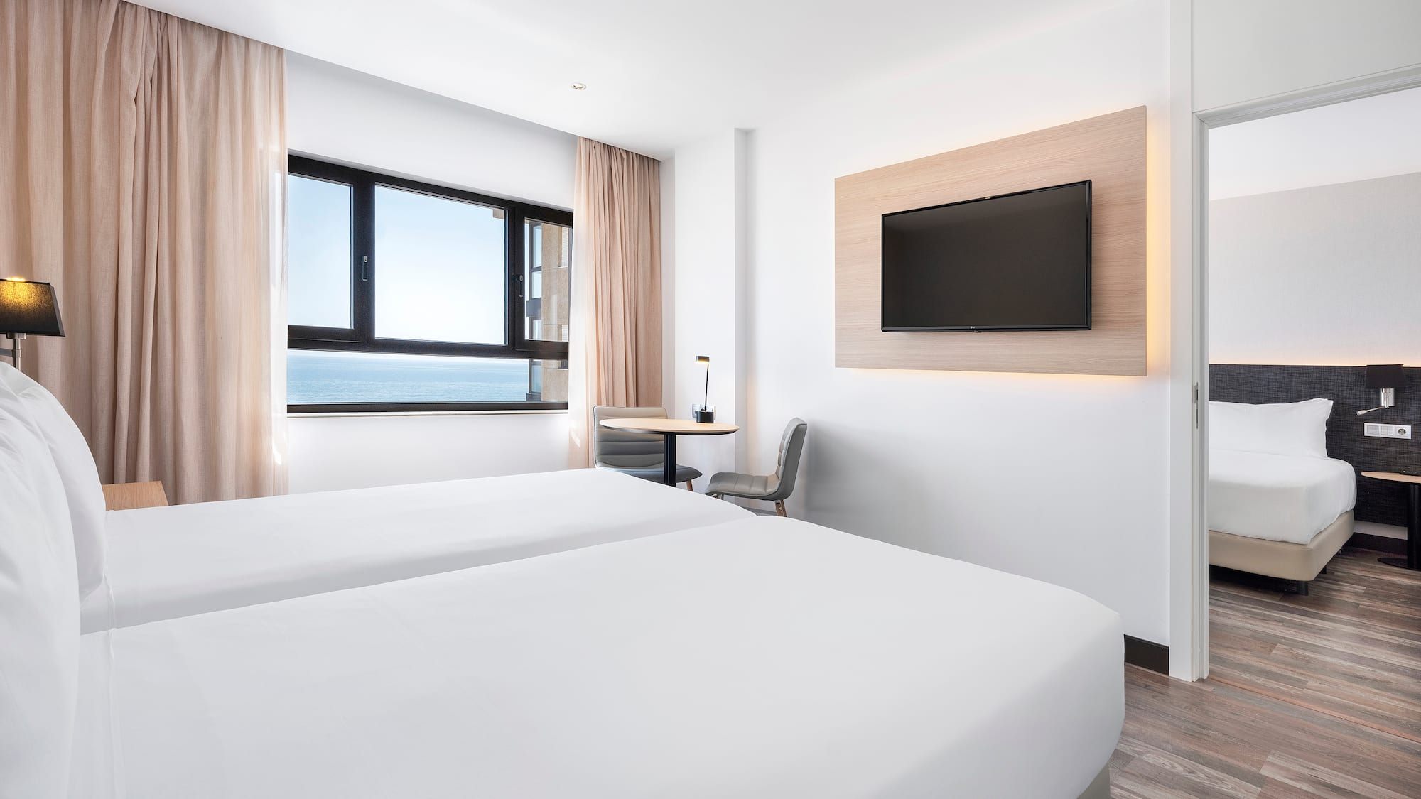 a room with two beds and a television