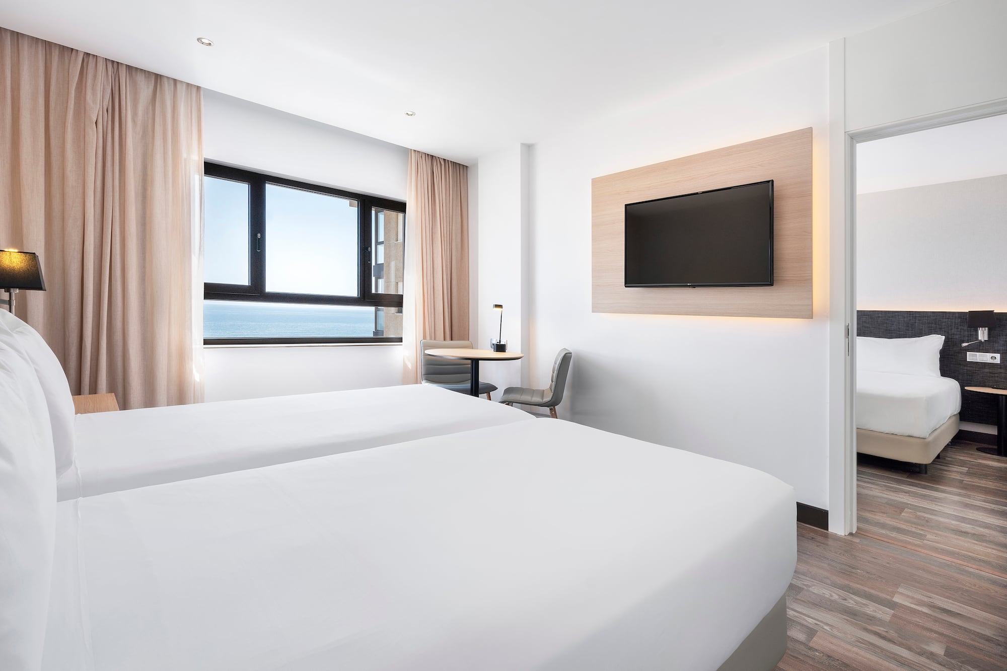 a room with two beds and a television