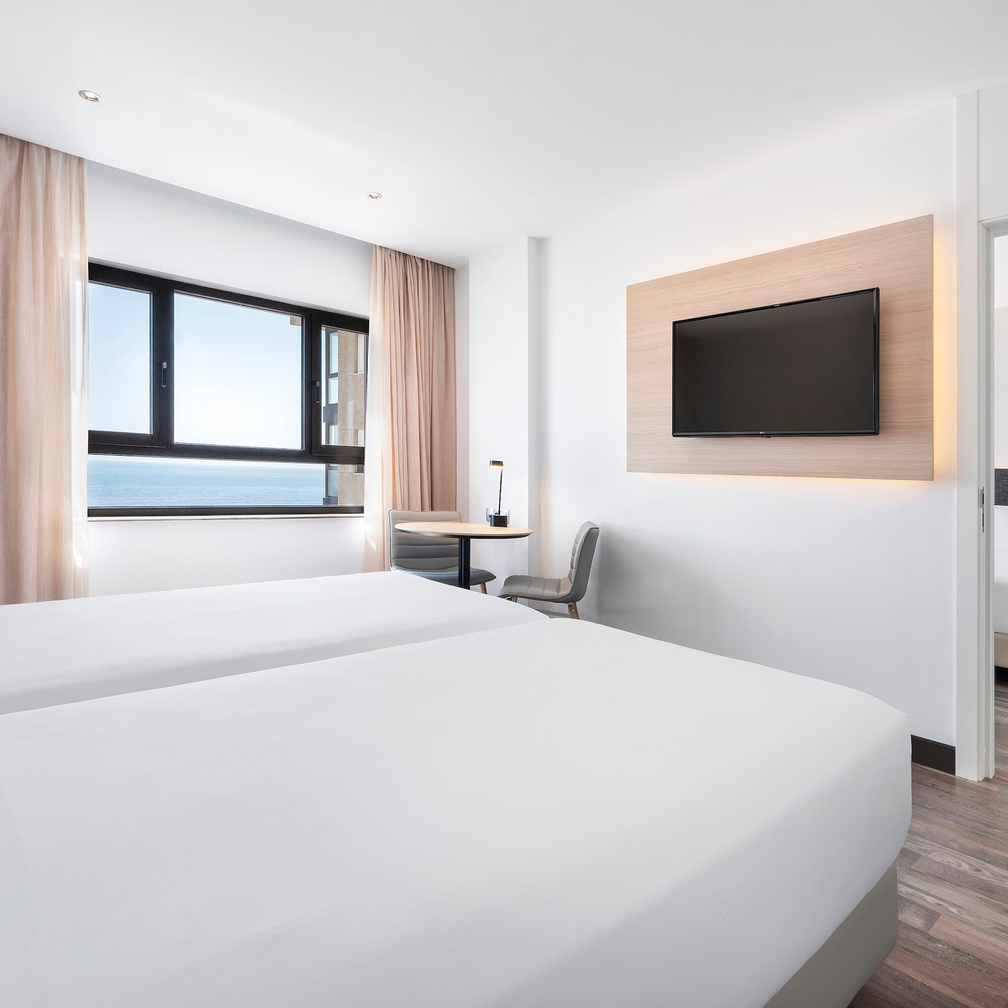 a room with two beds and a television