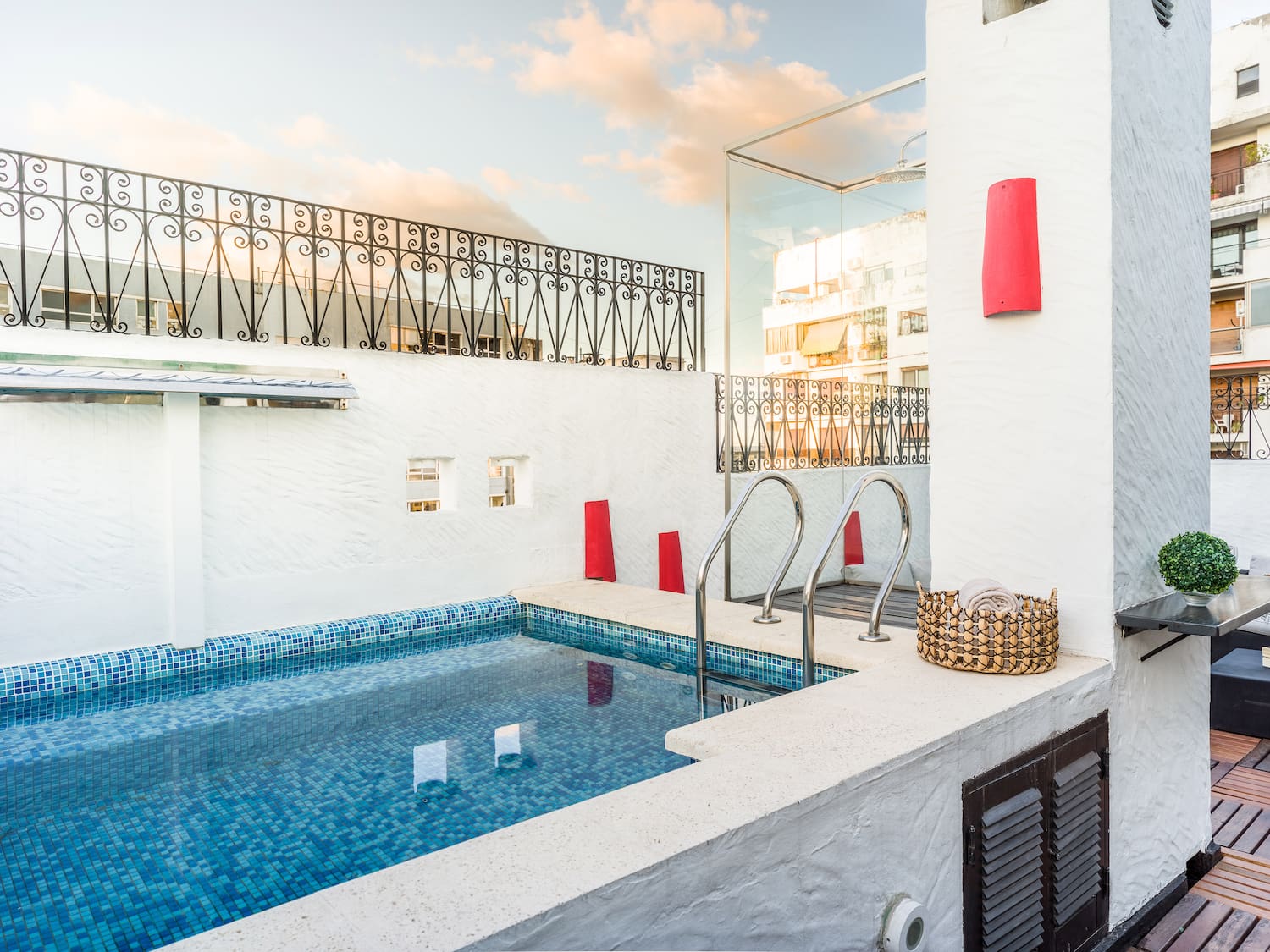 a pool with stairs and a basket on the side
