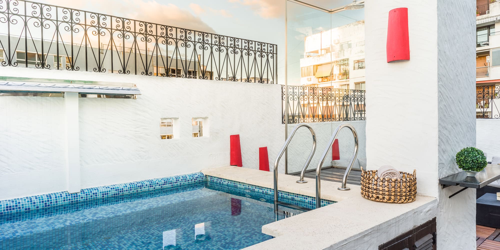 a pool with stairs and a basket on the side