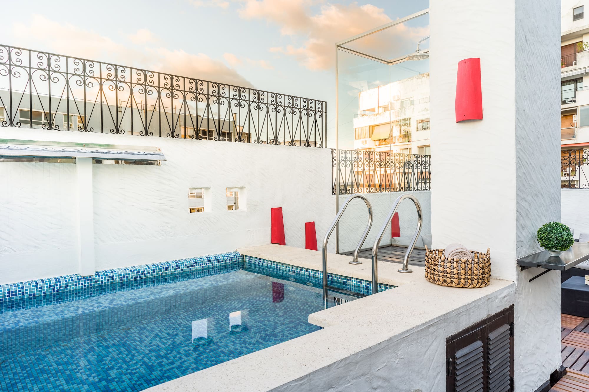 a pool with stairs and a basket on the side