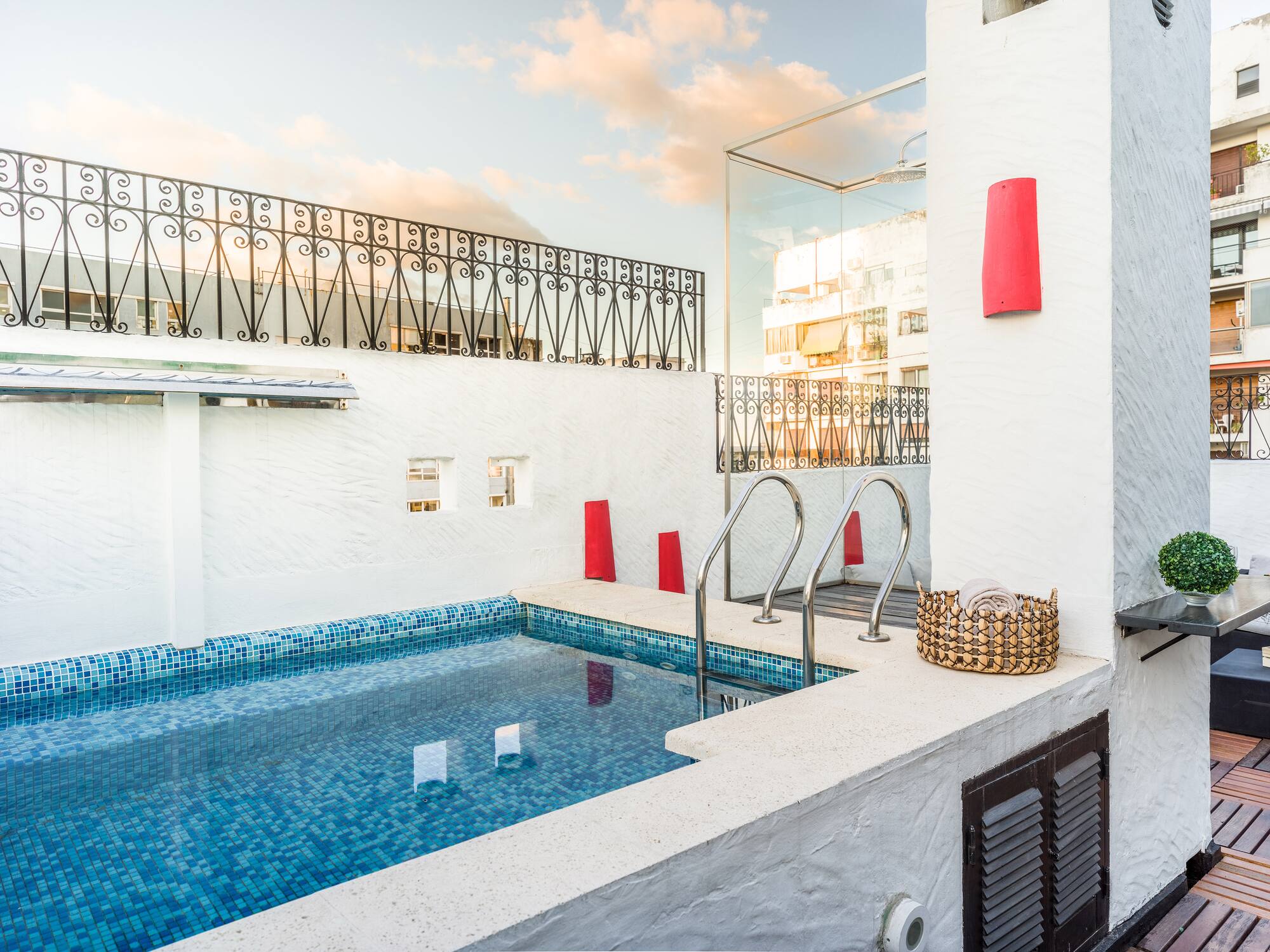a pool with stairs and a basket on the side