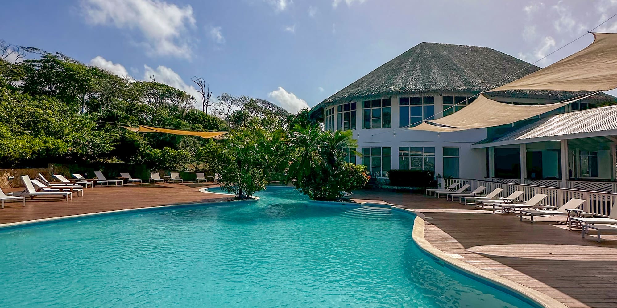 a pool with a building and trees
