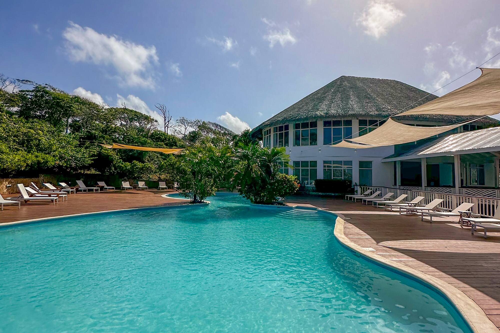a pool with a building and trees