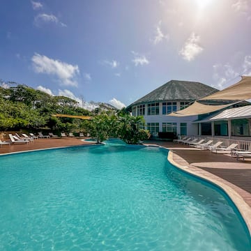 a pool with a building and trees