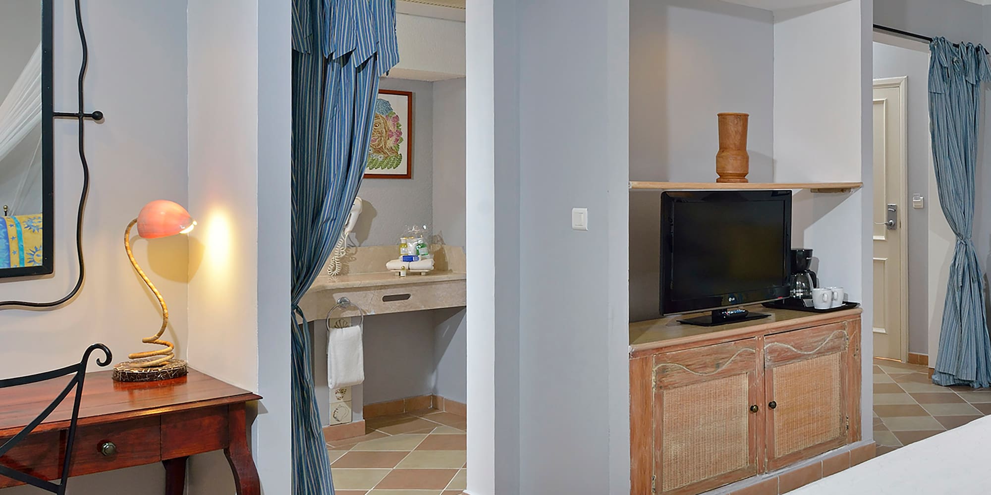 a room with a bed and a desk and a mirror