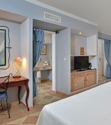 a room with a bed and a desk and a mirror