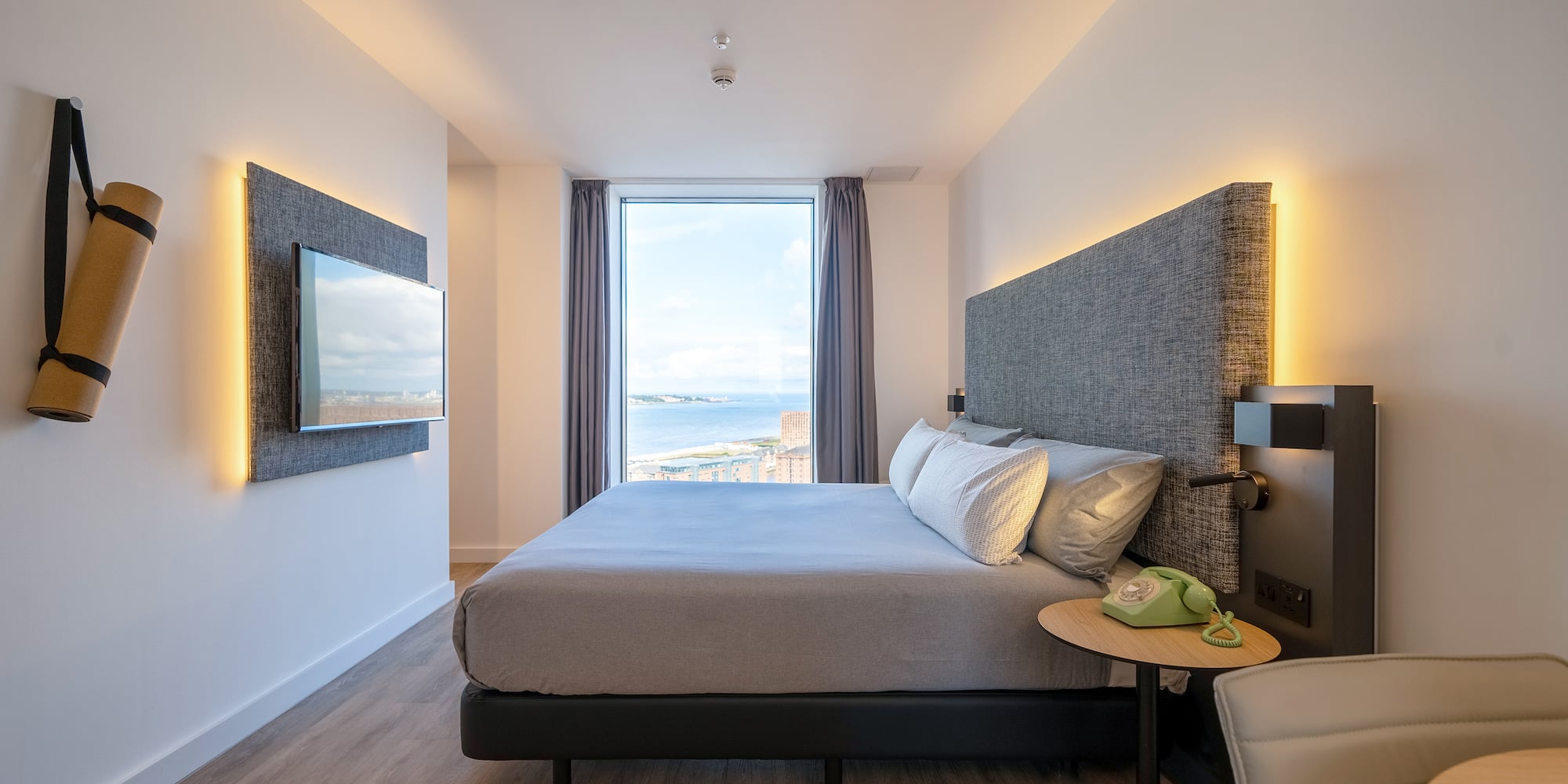 a room with a large bed and a large window