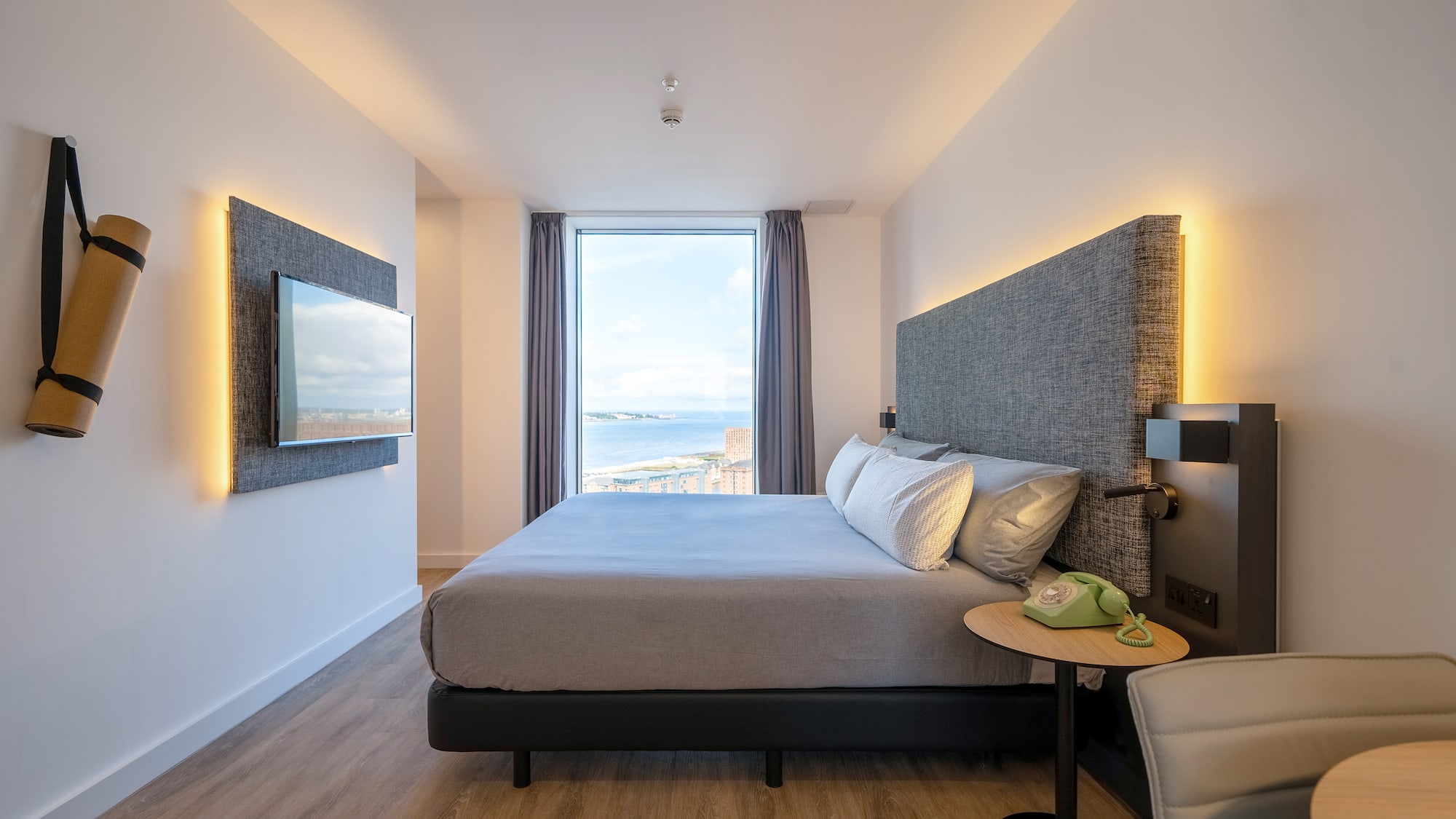 a room with a large bed and a large window