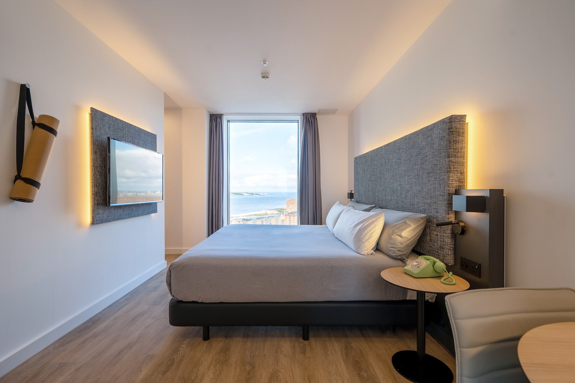 a room with a large bed and a large window