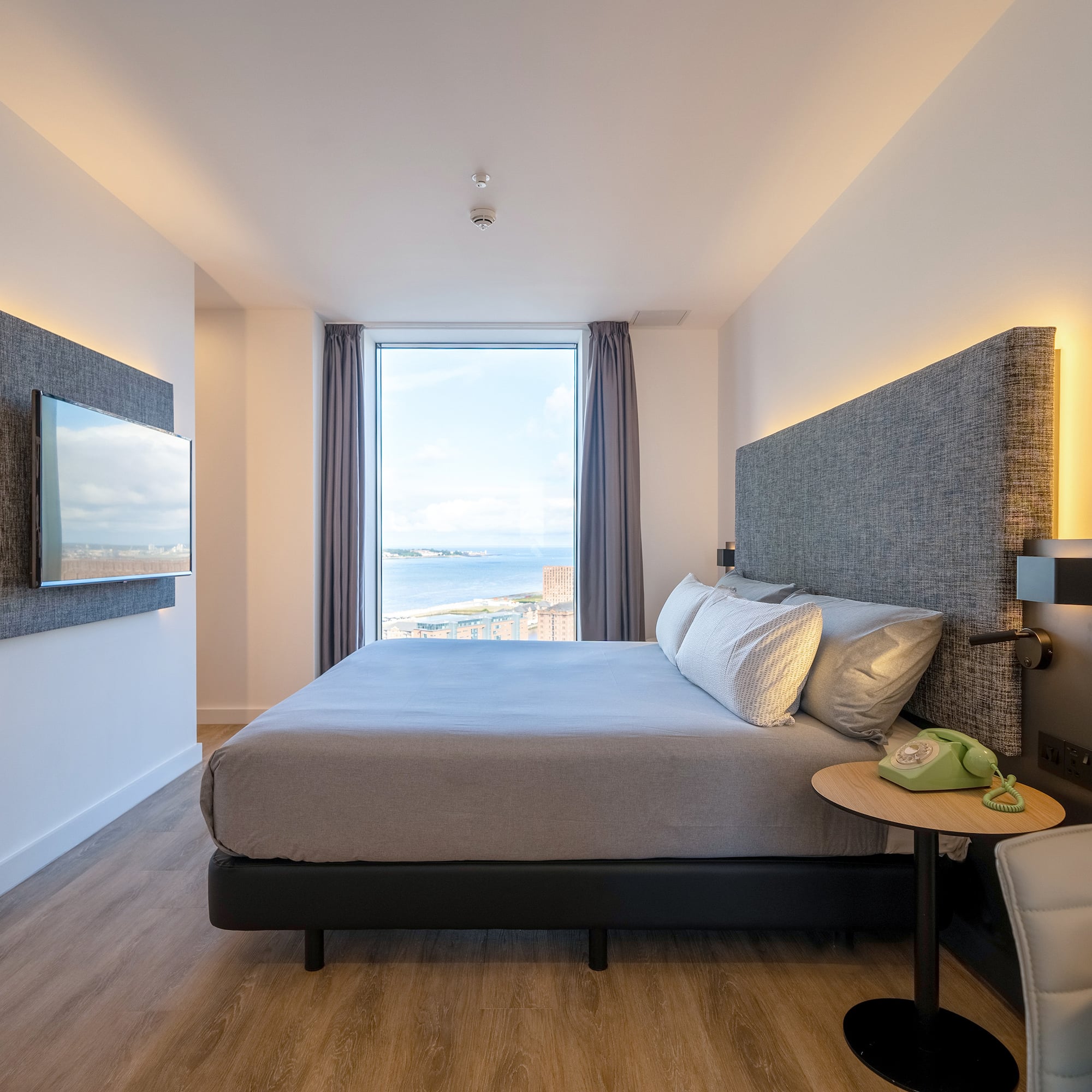 a room with a large bed and a large window