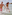 Couple running in splashing ocean water, holding hands, sunny beach day.
