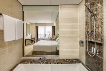 a bathroom with a mirror and a bed