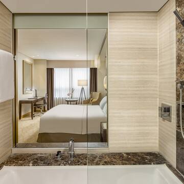 a bathroom with a mirror and a bed