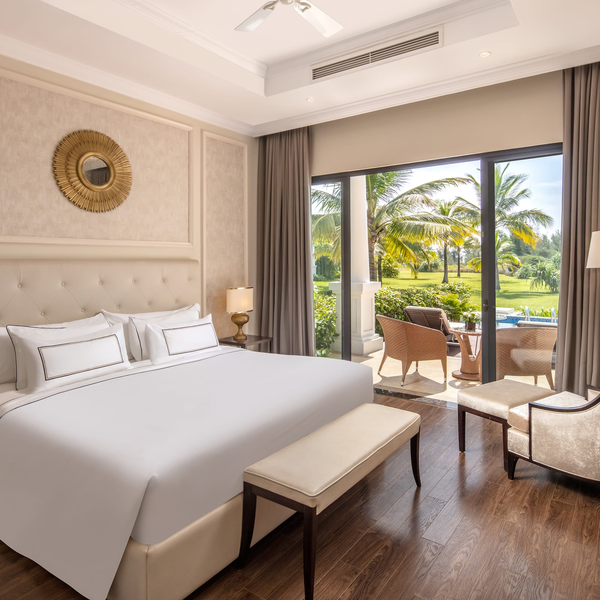 a bedroom with a large bed and chairs