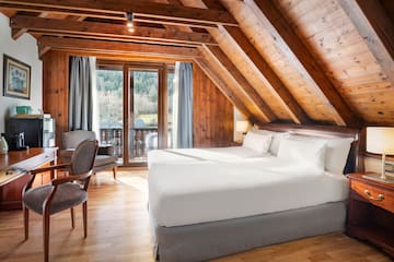 a bedroom with a wood ceiling and a wood floor