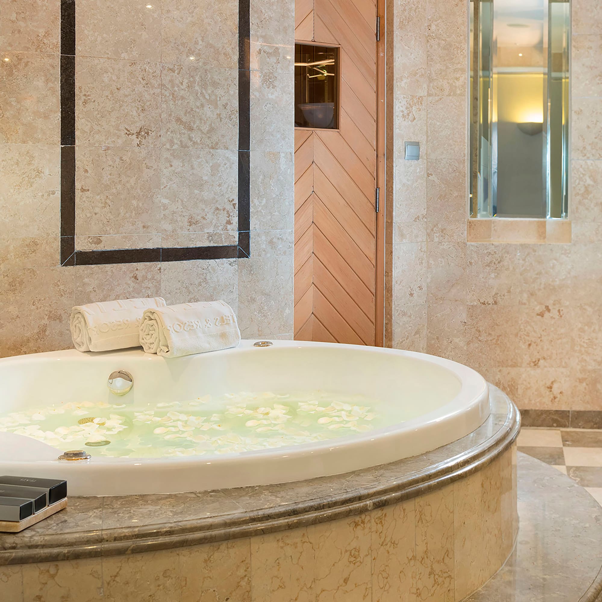 a large bathtub with flowers in it