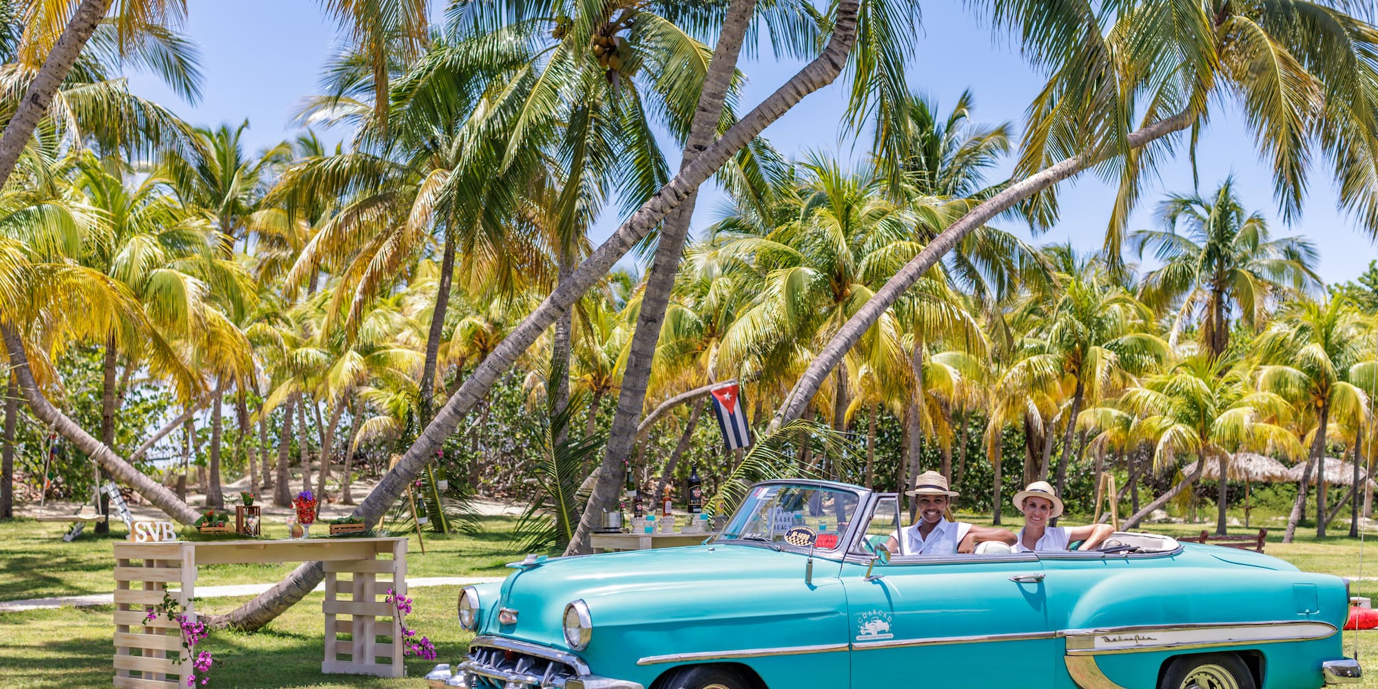 a group of people in a convertible car