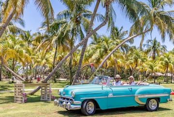 a group of people in a convertible car