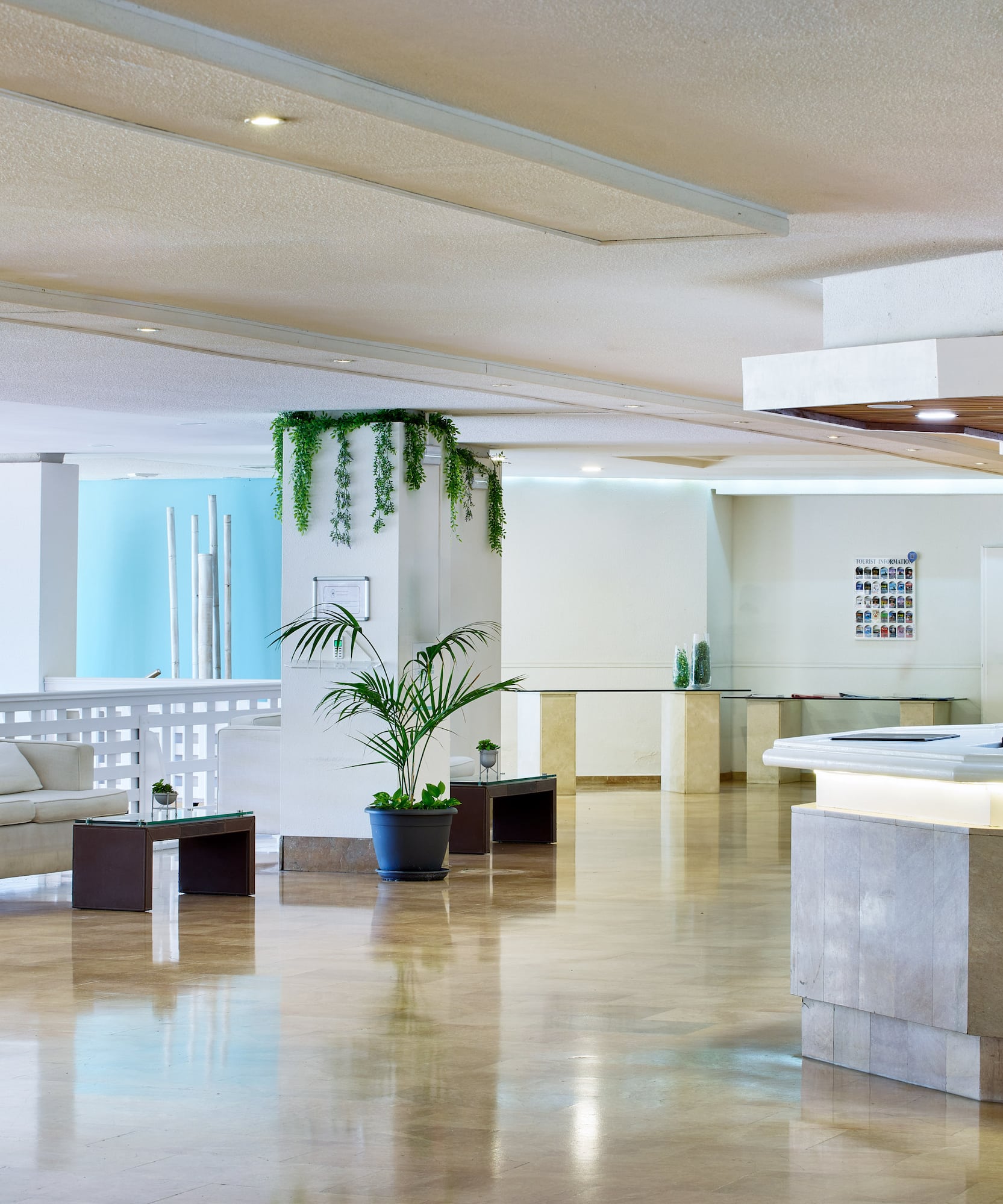 a large room with a reception desk and a white couch