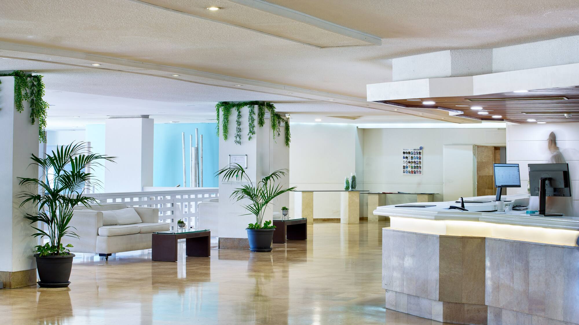 a large room with a reception desk and a white couch