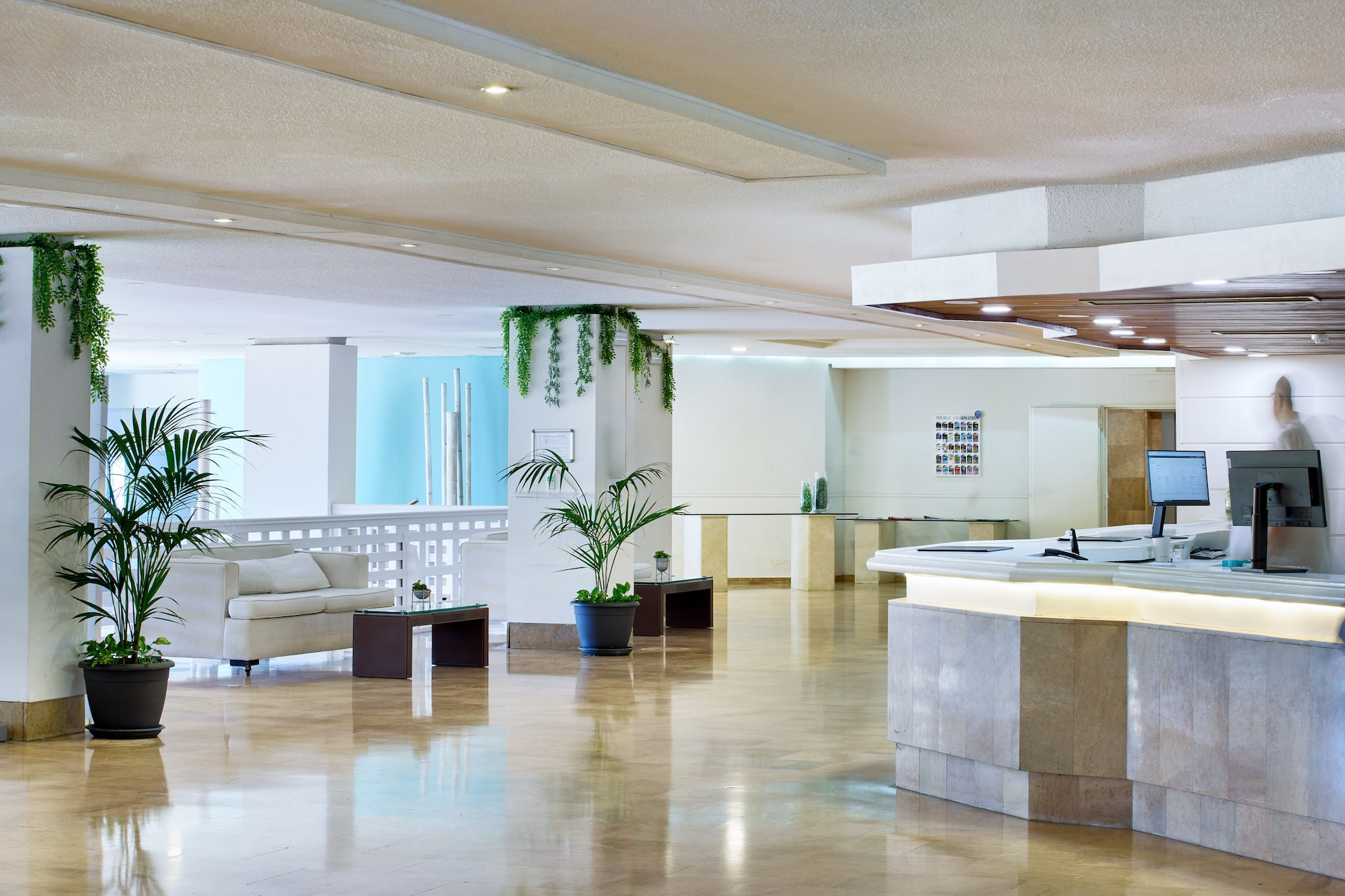 a large room with a reception desk and a white couch
