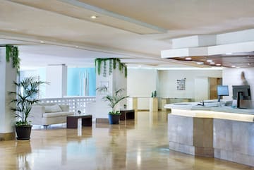 a large room with a reception desk and a white couch