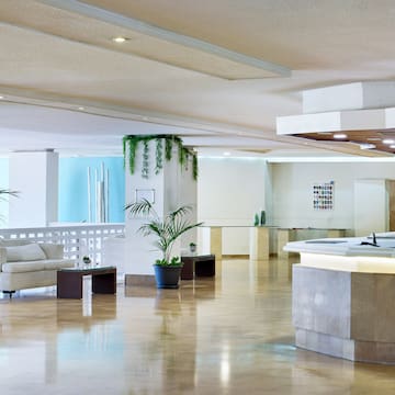 a large room with a reception desk and a white couch