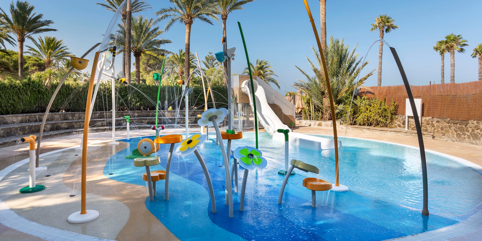 a water park with a water slide and trees