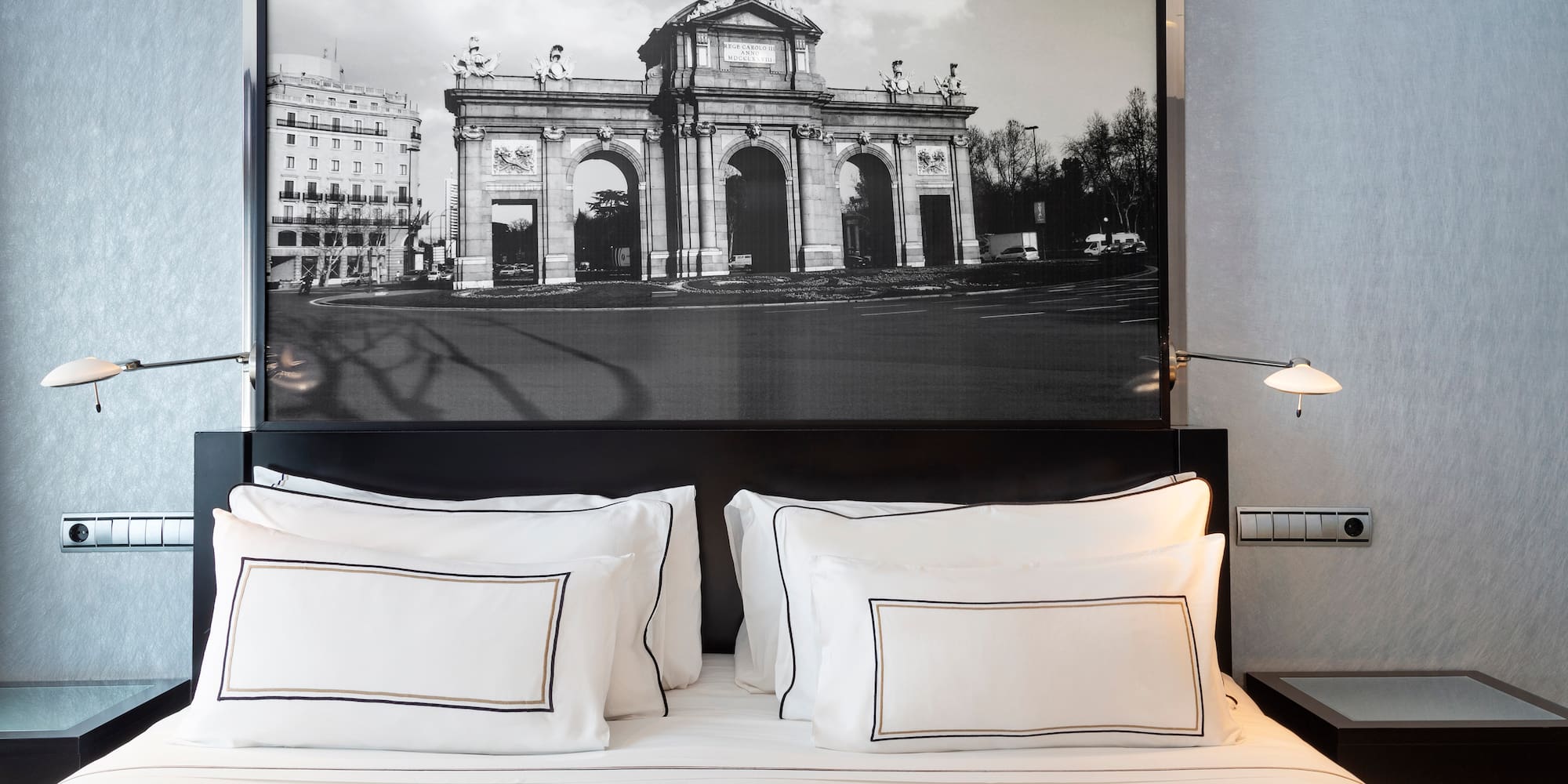 a bed with a picture above it