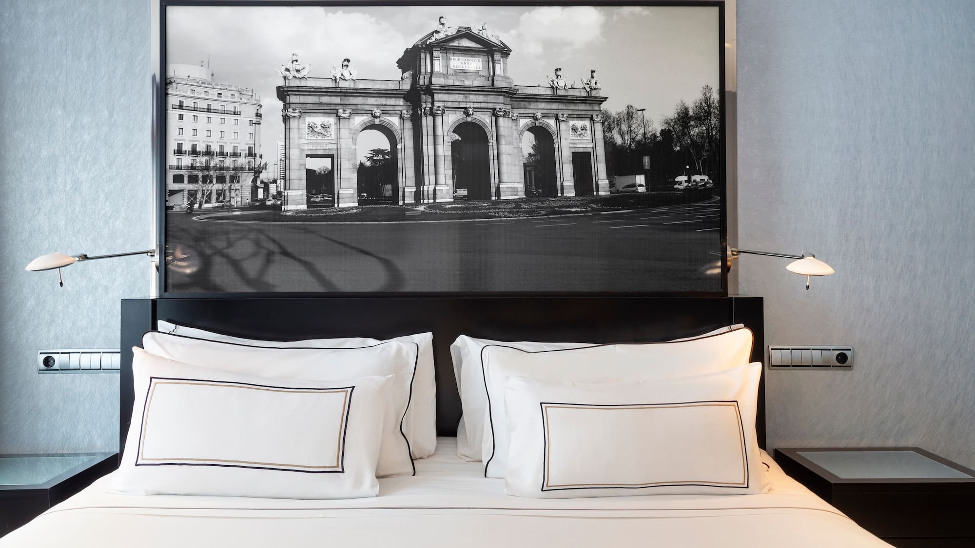 a bed with a picture above it