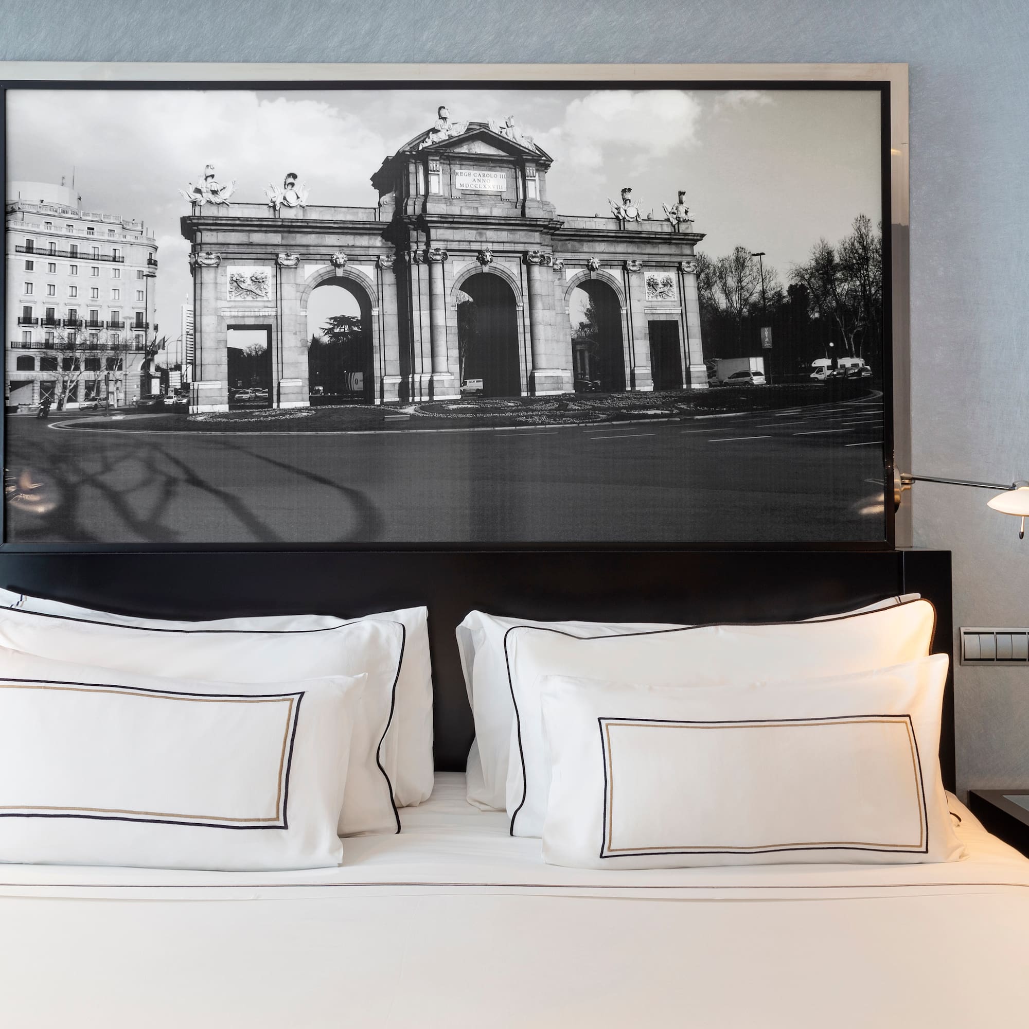 a bed with a picture above it