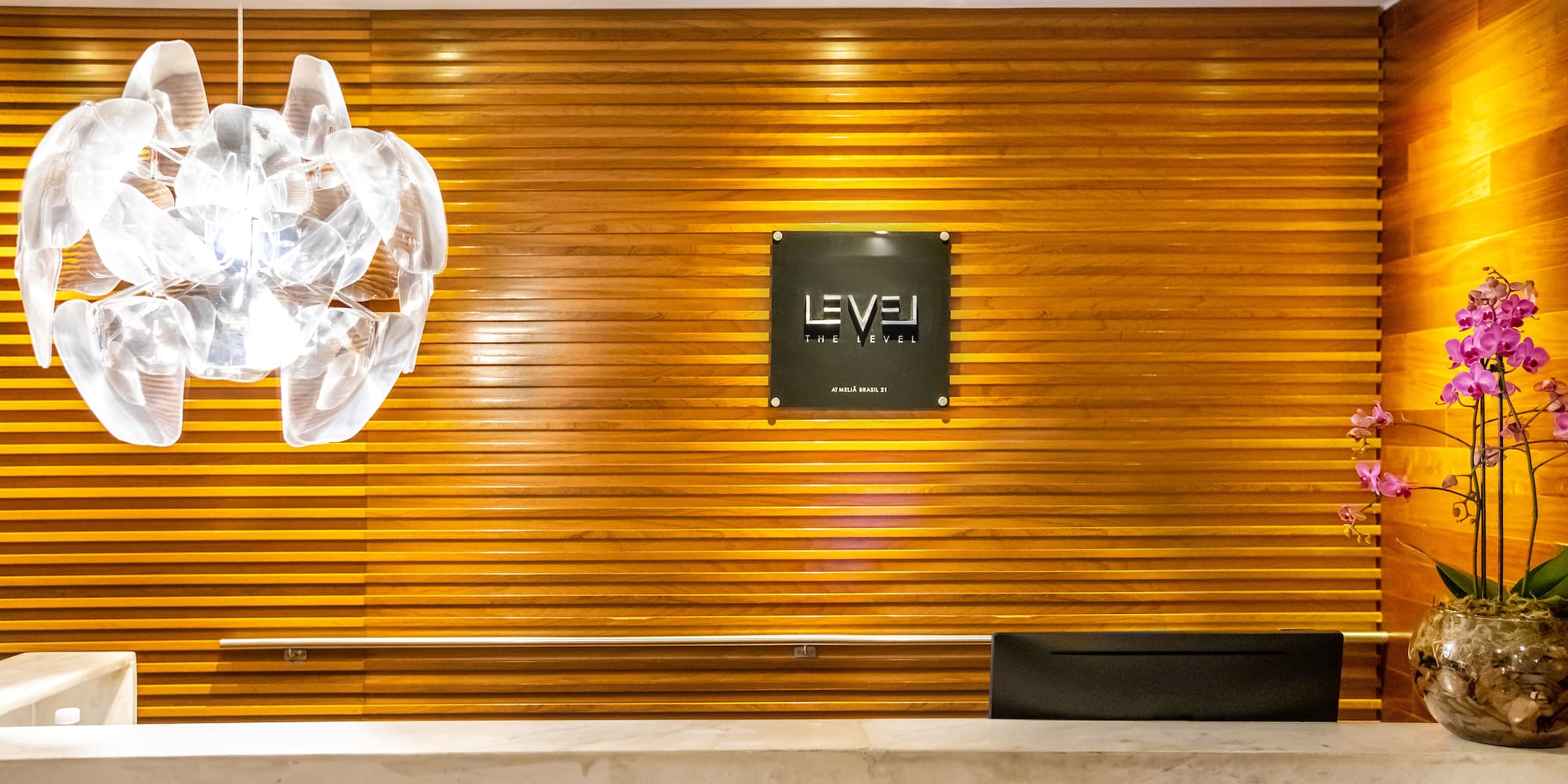 a reception desk with a sign on the wall