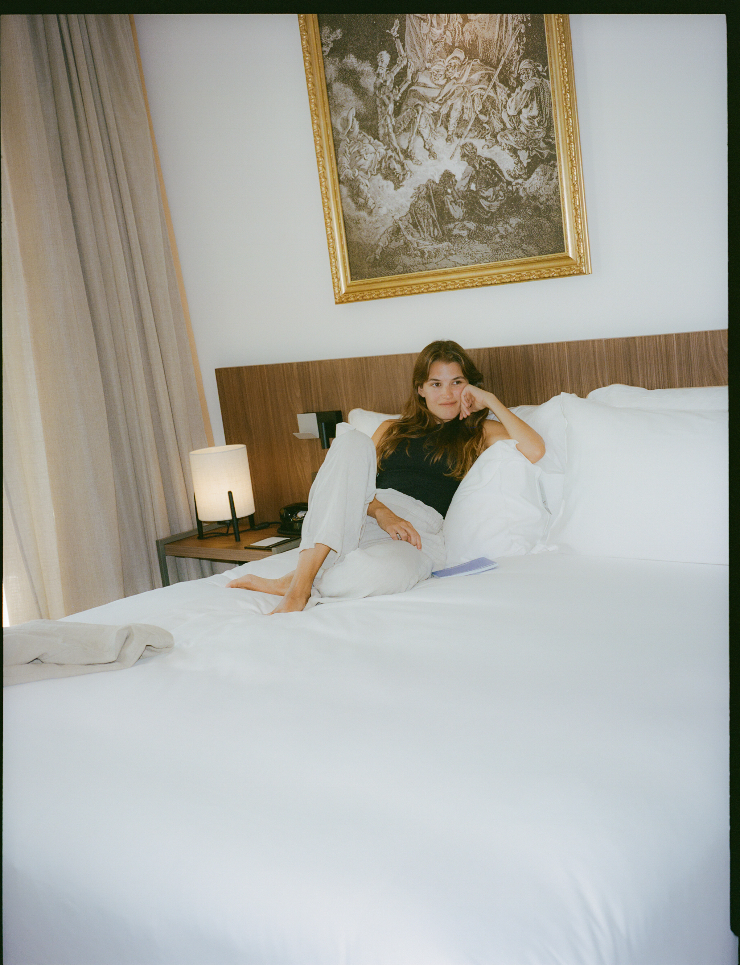 a woman sitting on a bed