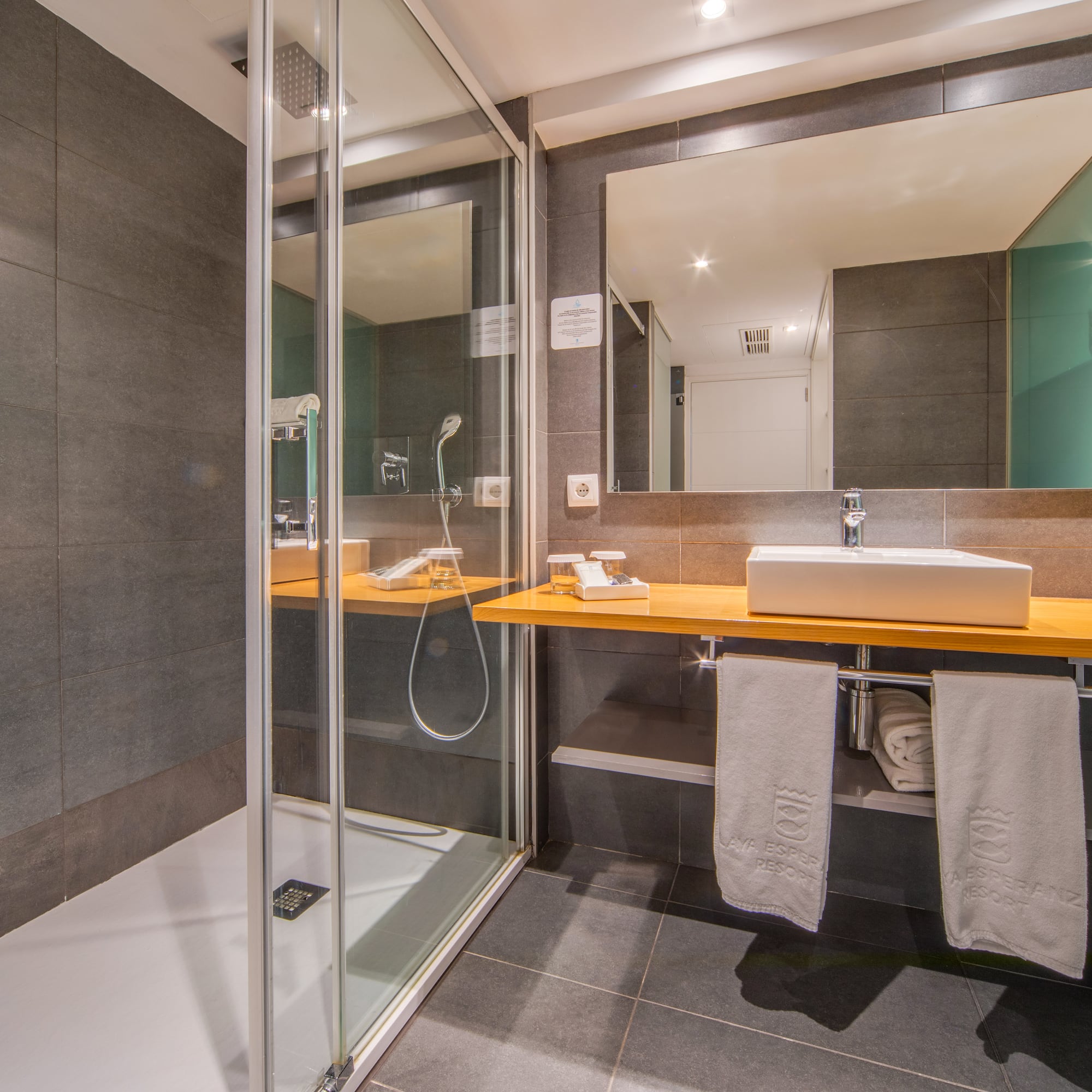 a bathroom with a shower and sink