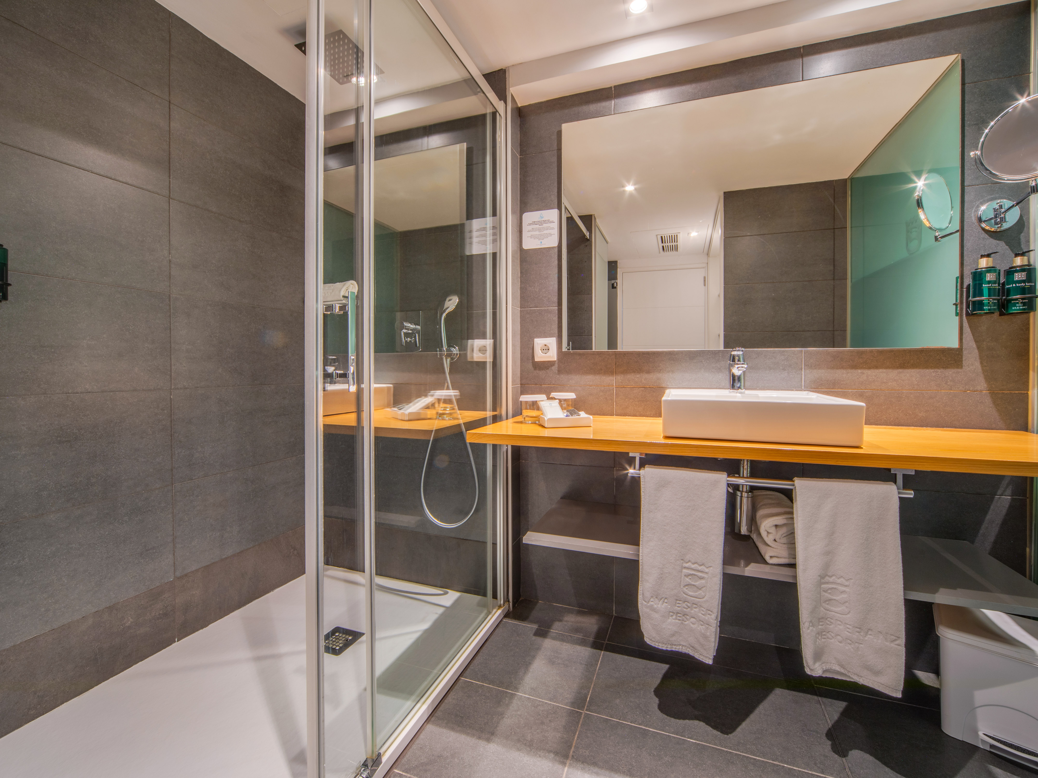 a bathroom with a shower and sink