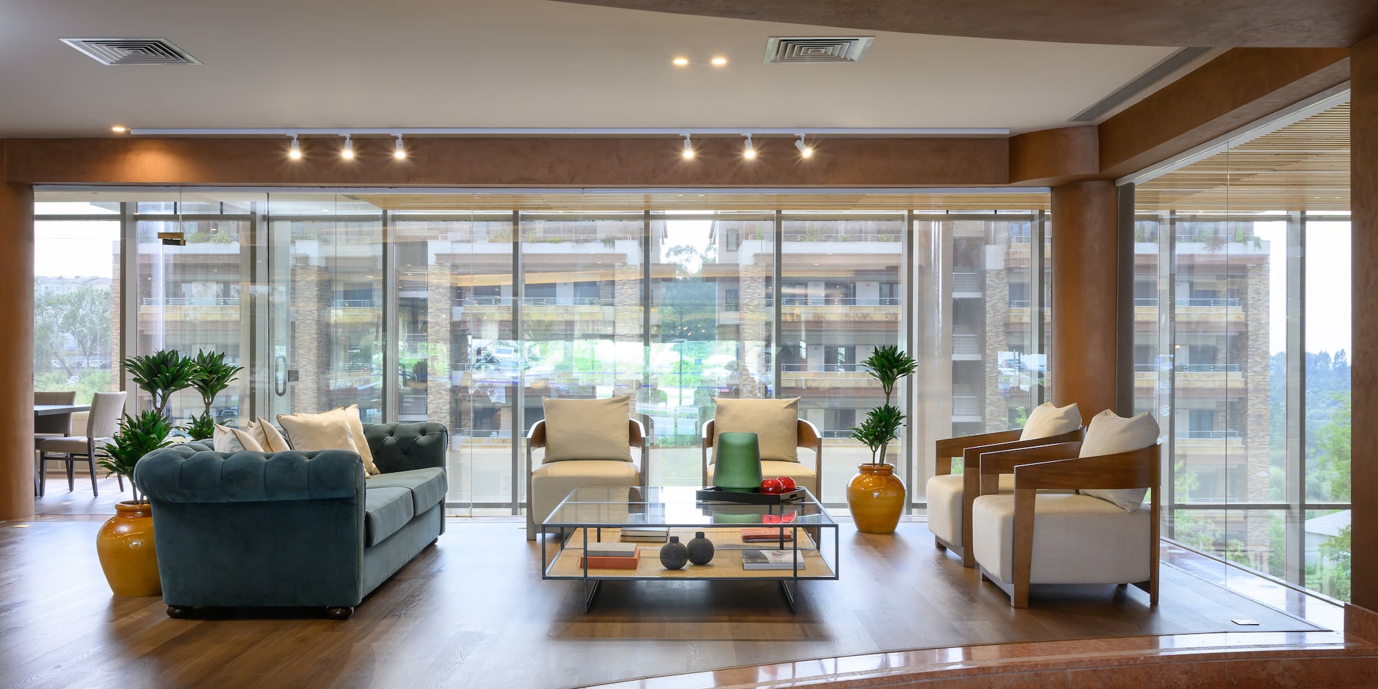 a room with a glass table and couches