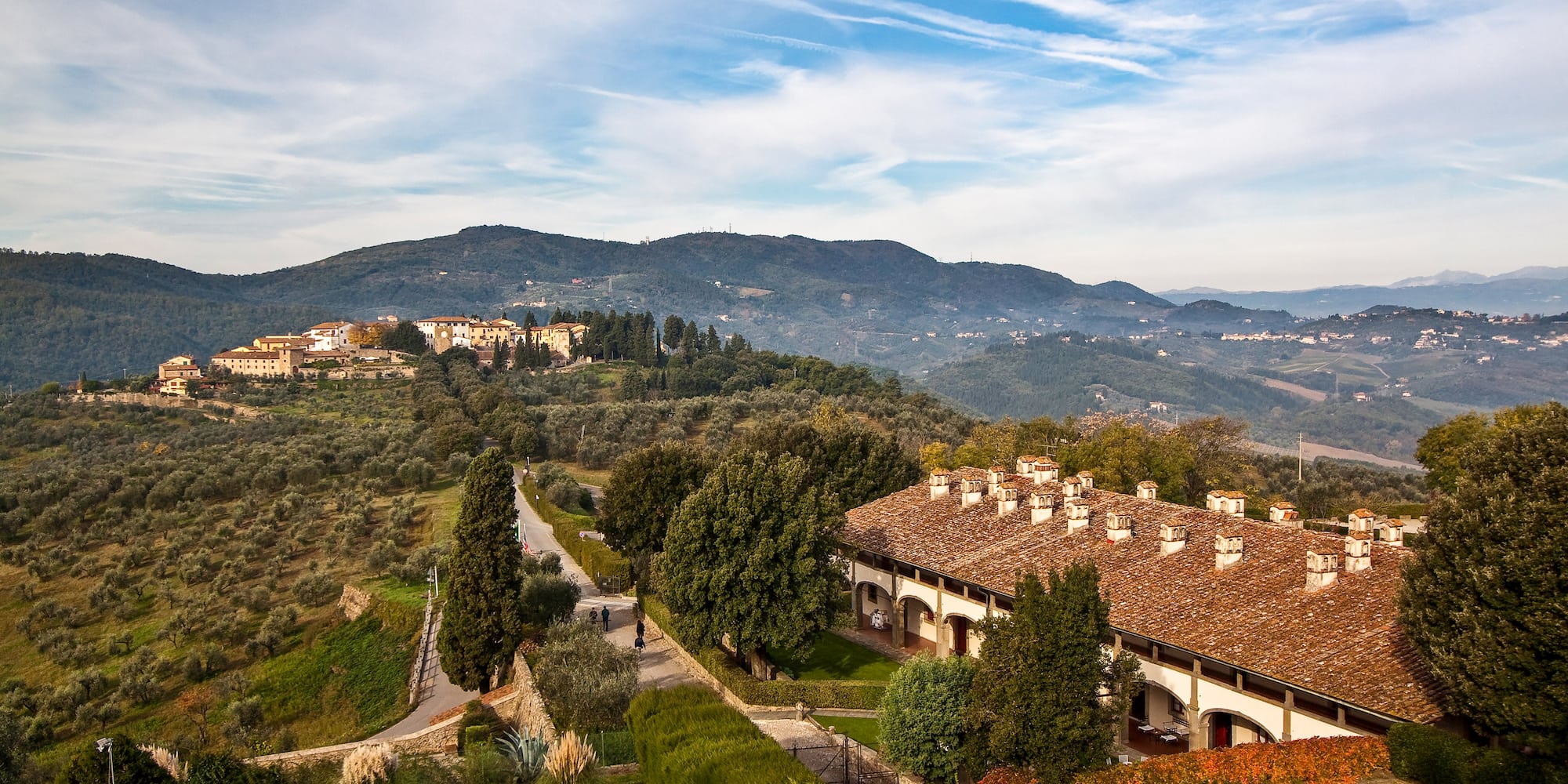 a building with trees and bushes in the background