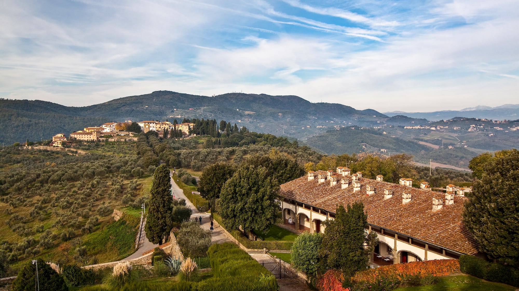 a building with trees and bushes in the background